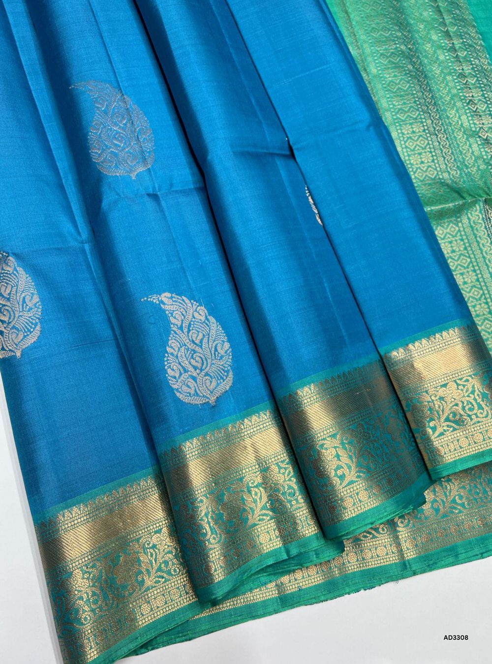 "Handwoven Fountain Blue body with Rexona pallu Bhutta Jacquard Border Soft Silk Saree featuring gold zari motifs and borders"