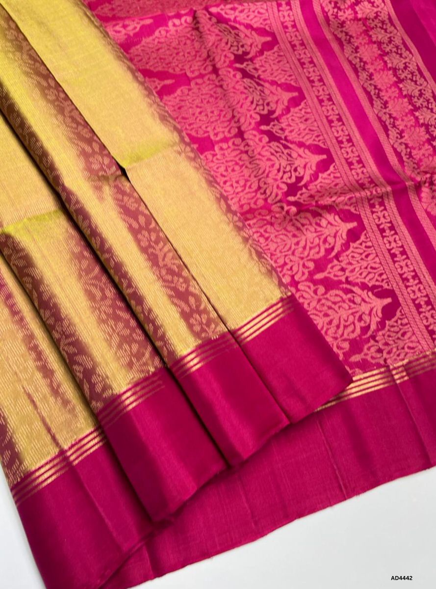 The Golden & Rani Pink Soft Silk Bridal Saree with Half Fine Tested Gold Zari is a radiant handwoven creation that unites regal brilliance with festive charm, making it ideal for weddings, receptions, and auspicious occasions.