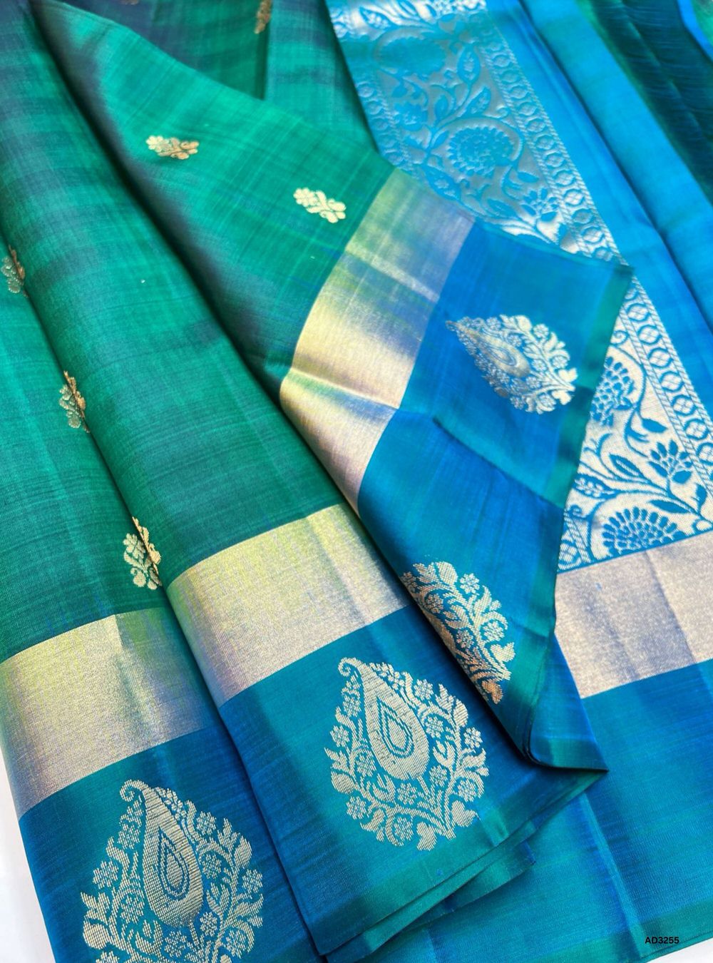 Handwoven Green body with Peacock Blue pallu Fancy Bhutta Soft Silk Saree featuring gold zari border"