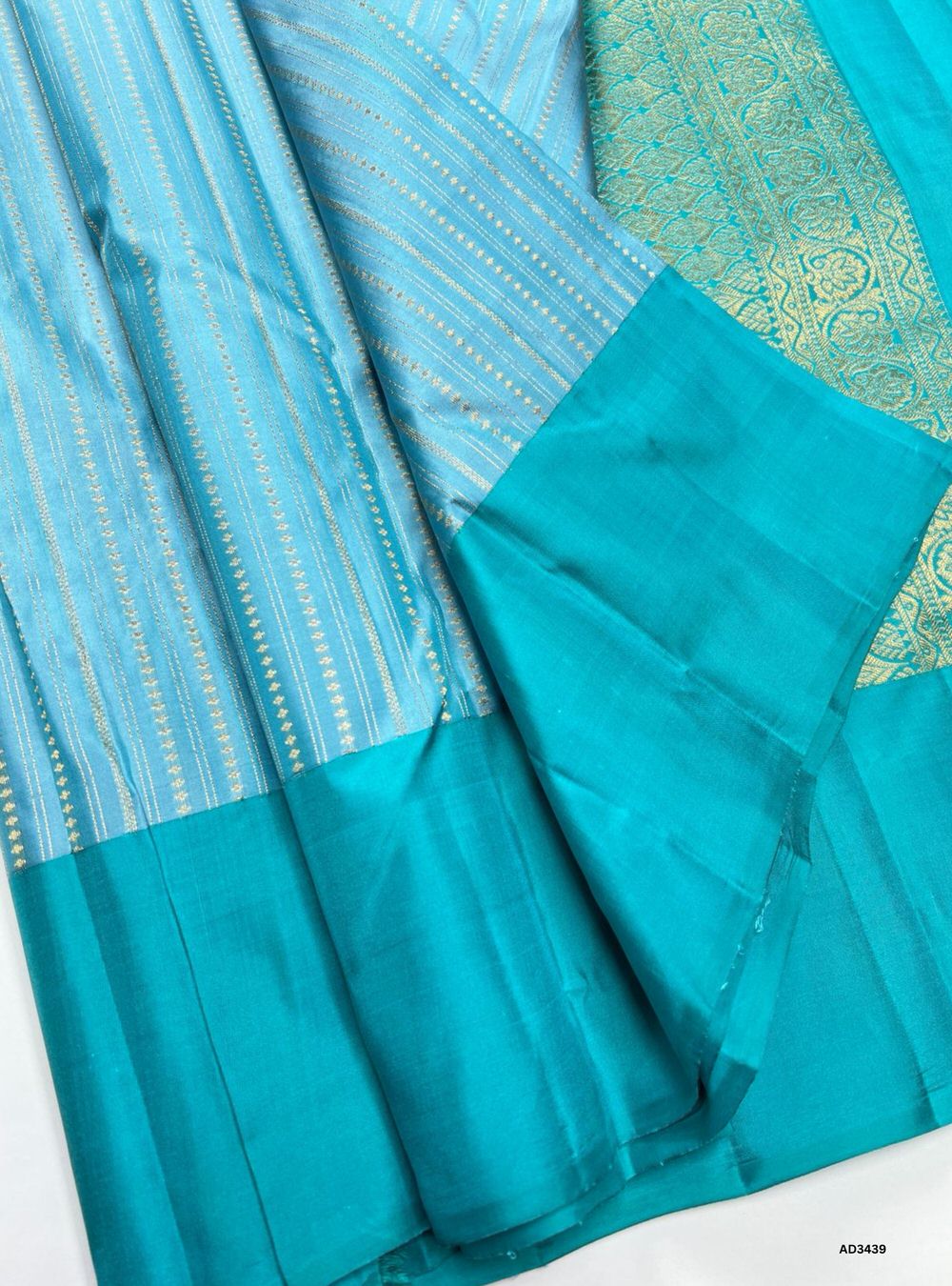 "Handwoven Ice Blue Bhutta Soft Silk Saree featuring gold zari motifs and borders"