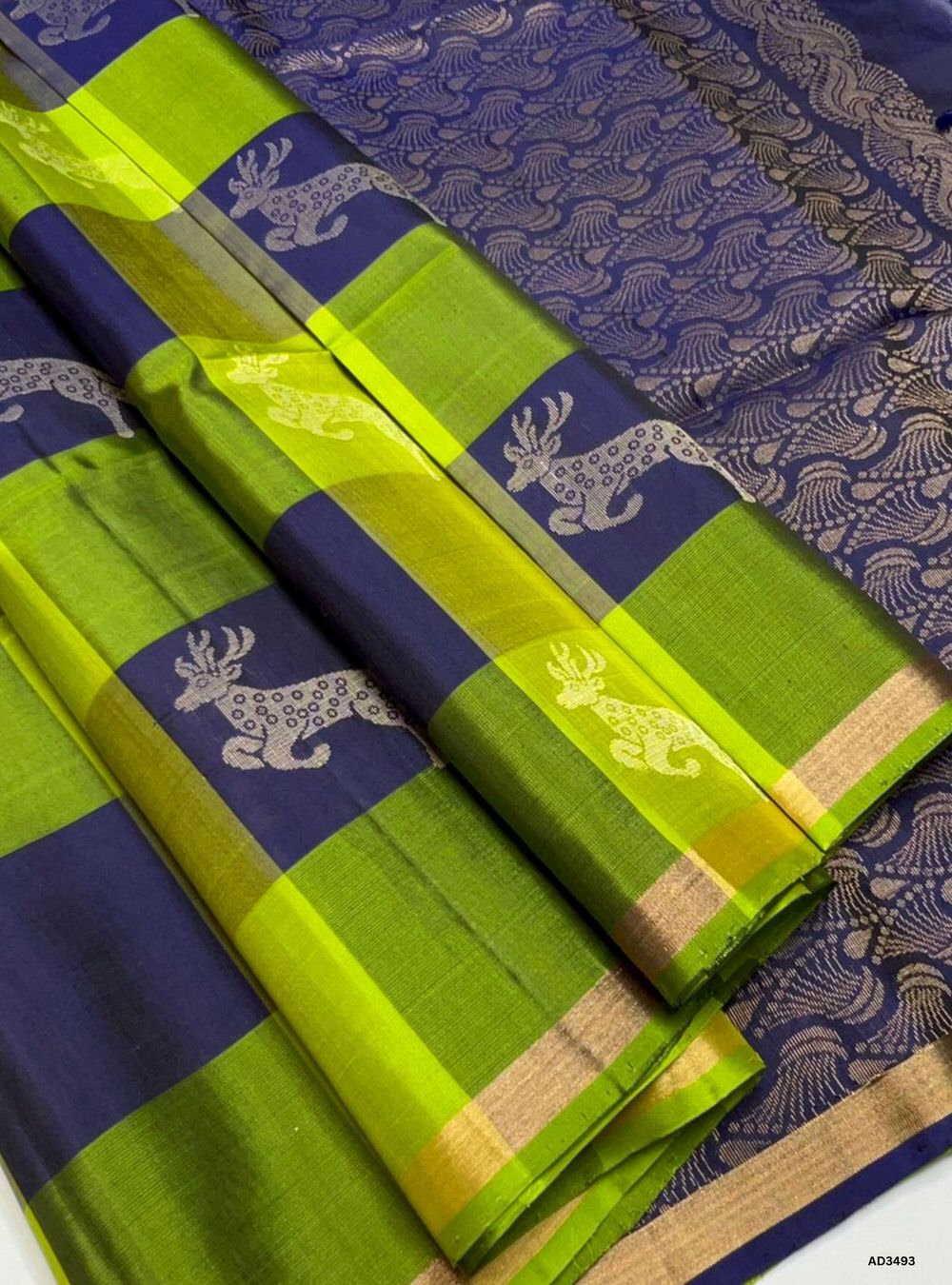 The Lime Green & Navy Soft Silk Saree is a vibrant handwoven creation featuring the traditional Pazhum Pazhamum checkered weave. The lively lime green base is beautifully contrasted with navy checks, while zari accents add a touch of brilliance. Perfect for weddings, festive occasions, and cultural gatherings, this saree blends heritage weaving with timeless elegance.
