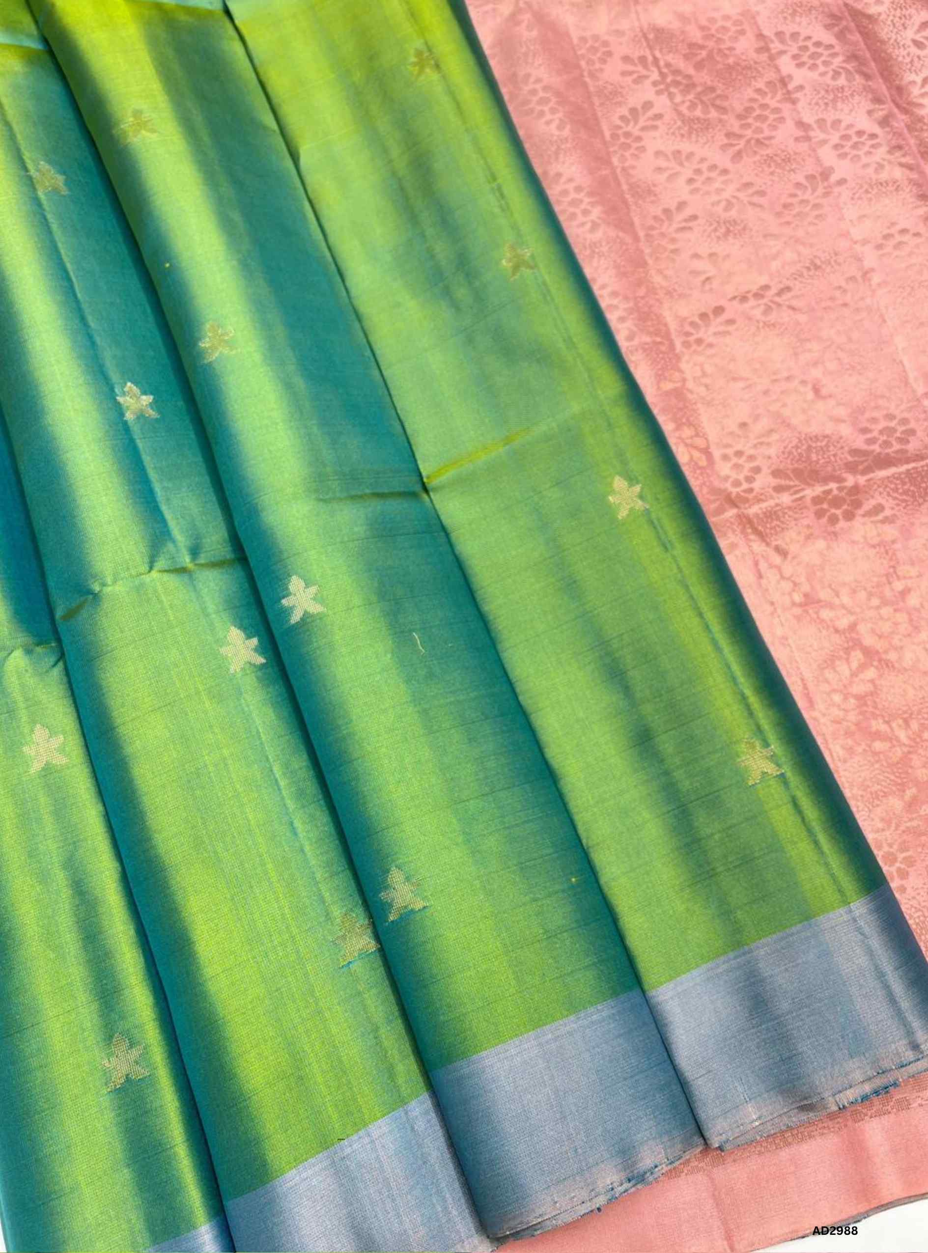 "Handwoven Lite Green body with Peach pallu Bhutta Soft Silk Saree featuring gold zari motifs
