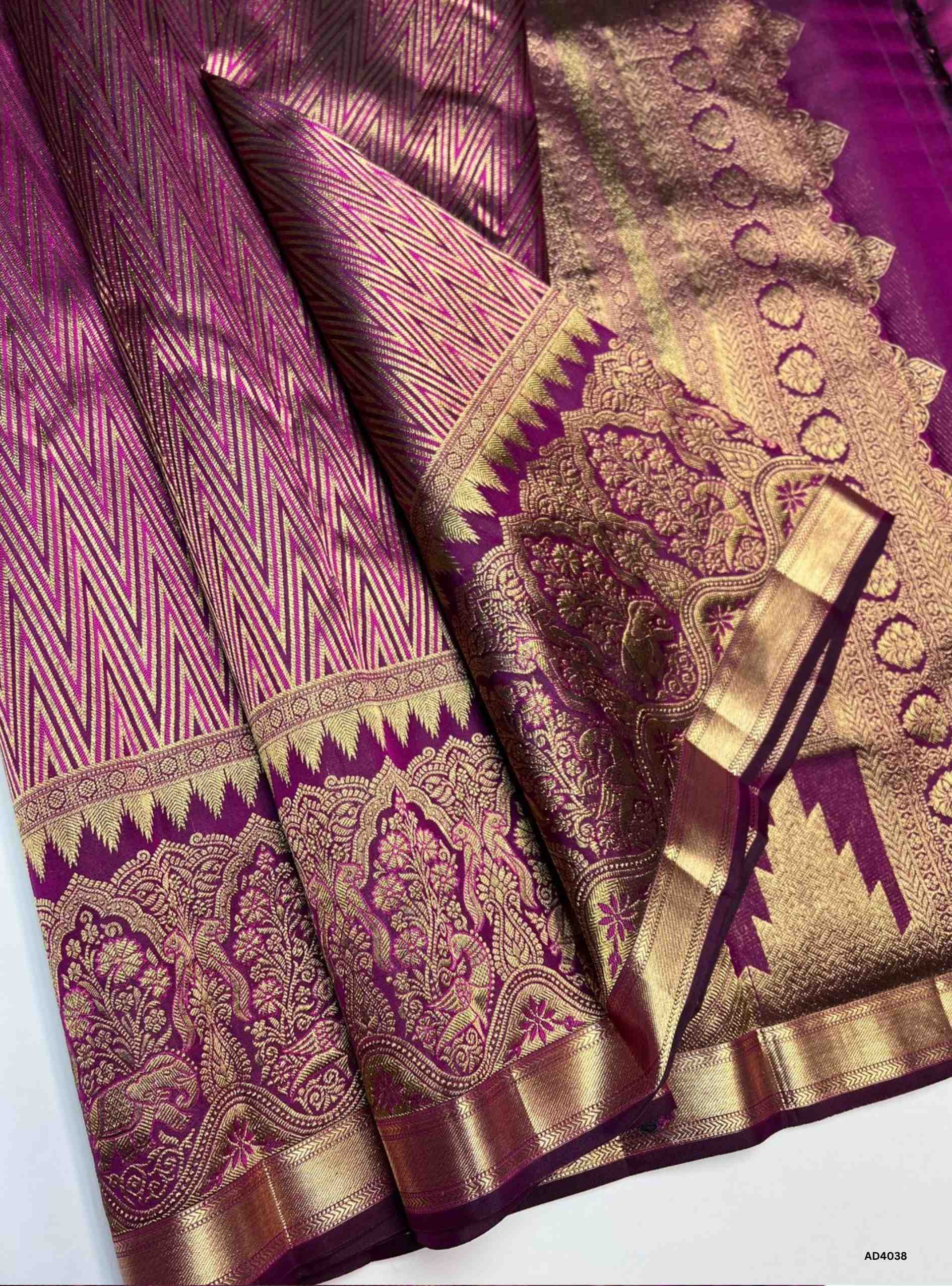 The Magenta Kanjeevaram Bridal Soft Silk Saree is a radiant handwoven masterpiece crafted for weddings and grand occasions. The vibrant magenta shade symbolizes auspicious joy, prosperity, and feminine grace, making it a timeless bridal choice. Its lustrous drape is enriched with heavy gold zari, temple‑inspired borders, and a grand pallu featuring motifs of peacocks, lotuses, and traditional geometric artistry. This saree embodies the heritage of Kanchipuram weaving, combining elegance with cultural grande