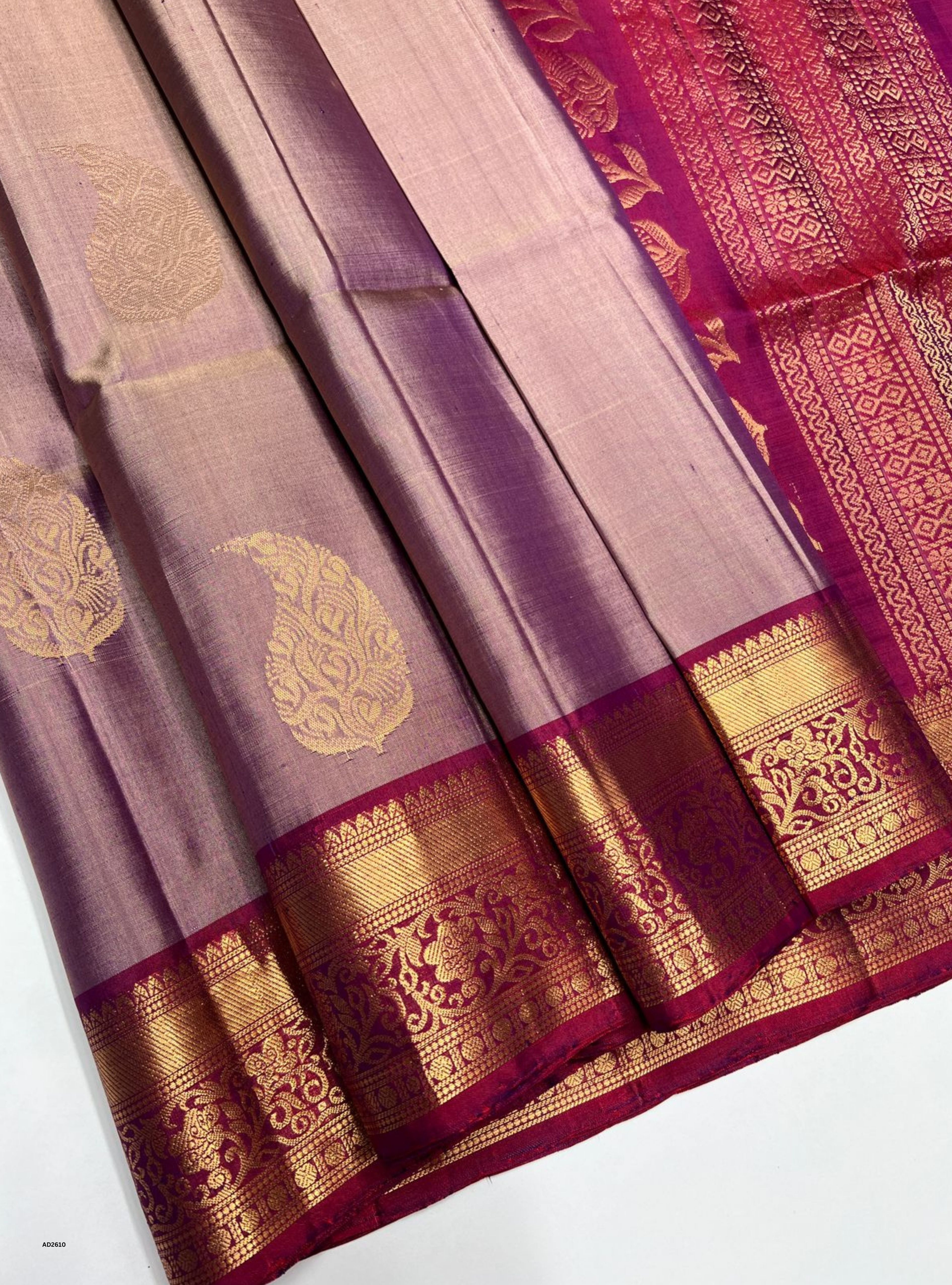 Traditional saree with intricate patterns and colors on a white background