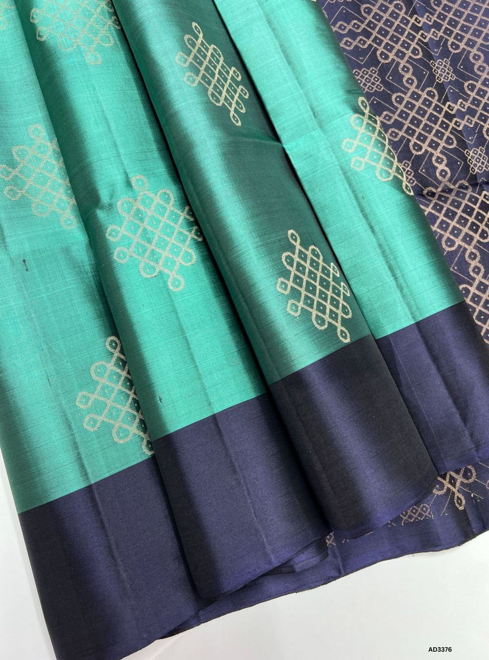 "Handwoven Mint Green body with Ink Blue pallu Kolam Soft Silk Saree featuring gold zari motifs and borders"