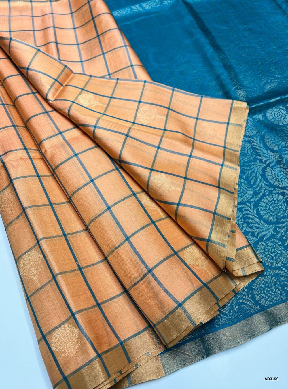 "Handwoven Muskmelon body with Rama Green pallu Checkered Bhutta Soft Silk Saree featuring gold zari motifs and borders"