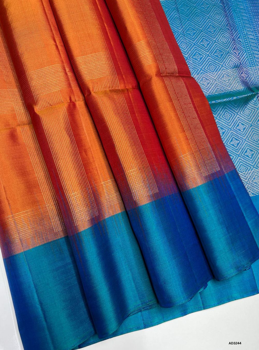 "Handwoven Orange body with Peacock Blue pallu Fancy Bhutta Soft Silk Saree featuring gold zari border"