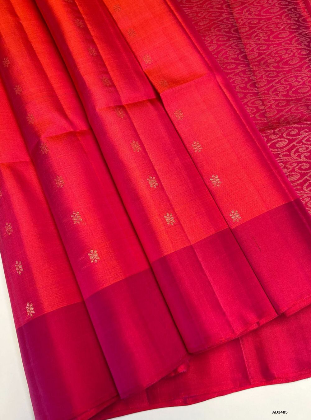 The Orangish Pink & Pink Soft Silk Saree is a graceful handwoven creation featuring traditional bhutta motifs across its body. The warm orangish pink base is beautifully contrasted with vibrant pink bhutta highlights, while zari accents add a luminous touch. Perfect for weddings, festive occasions, and cultural gatherings, this saree blends heritage weaving with timeless elegance.