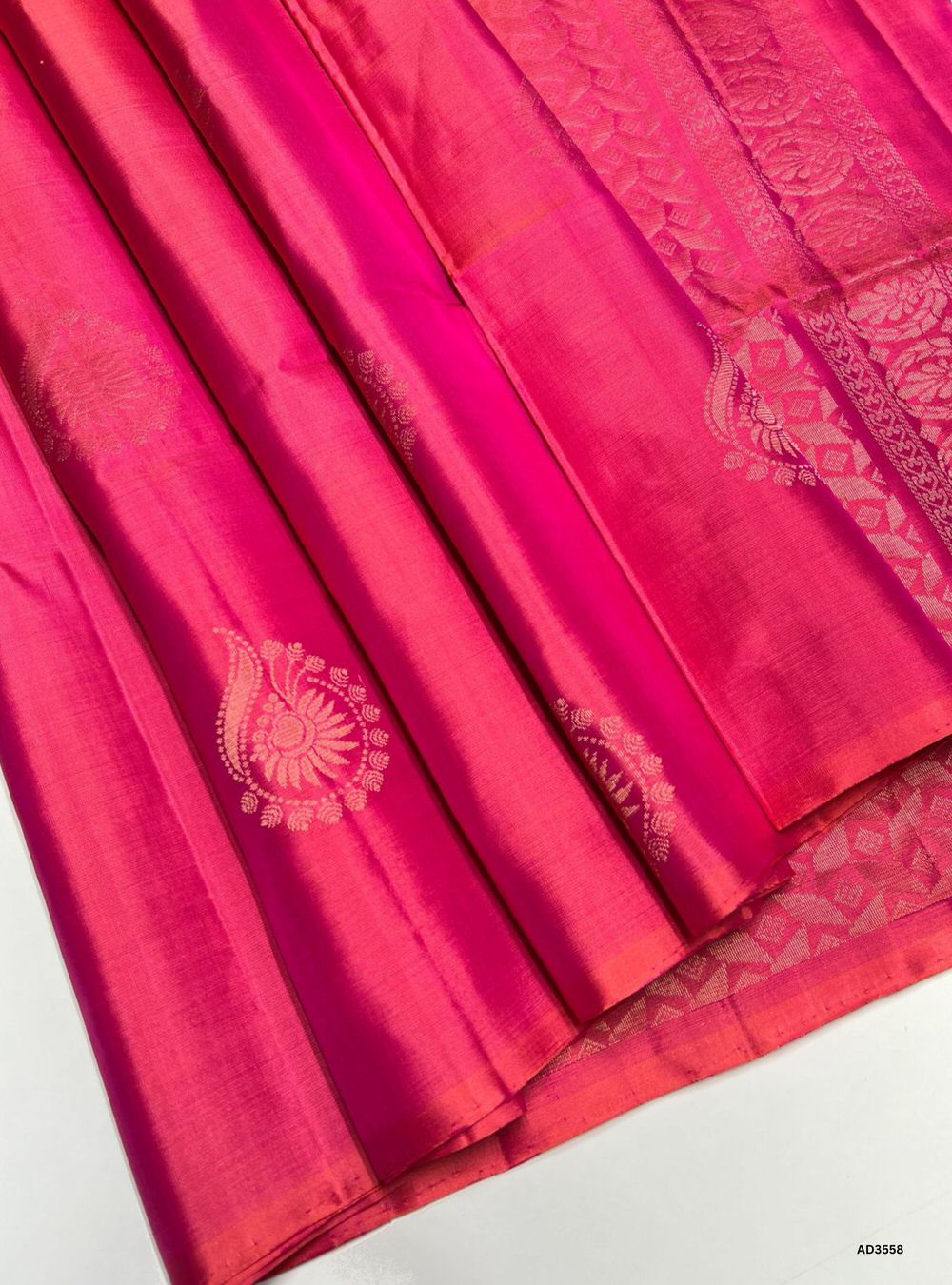 The Peachish Pink Soft Silk Saree is a graceful handwoven creation featuring a delicate pastel body adorned with traditional Bhutta motifs. The matching border and pallu enhance its subtle charm, while zari highlights shimmer across the motifs. Perfect for weddings, festive occasions, and cultural gatherings, this saree blends soft elegance with timeless Bhutta craftsmanship