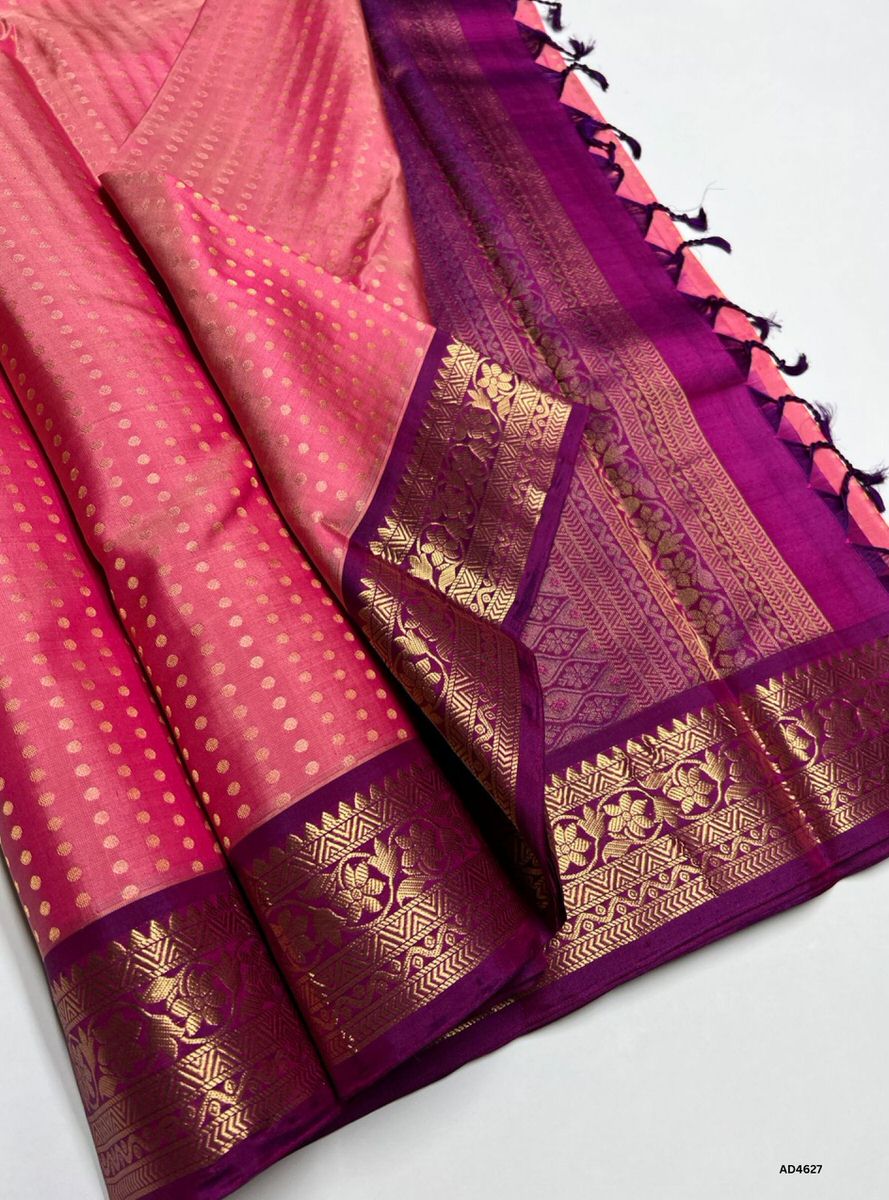 The Pink & Purple Kanchi Border Soft Silk Saree with 1000 Bhutta and Half Fine Tested Gold Zari is a radiant handwoven creation that unites festive charm with regal depth, making it perfect for weddings, temple ceremonies, and cultural celebrations.