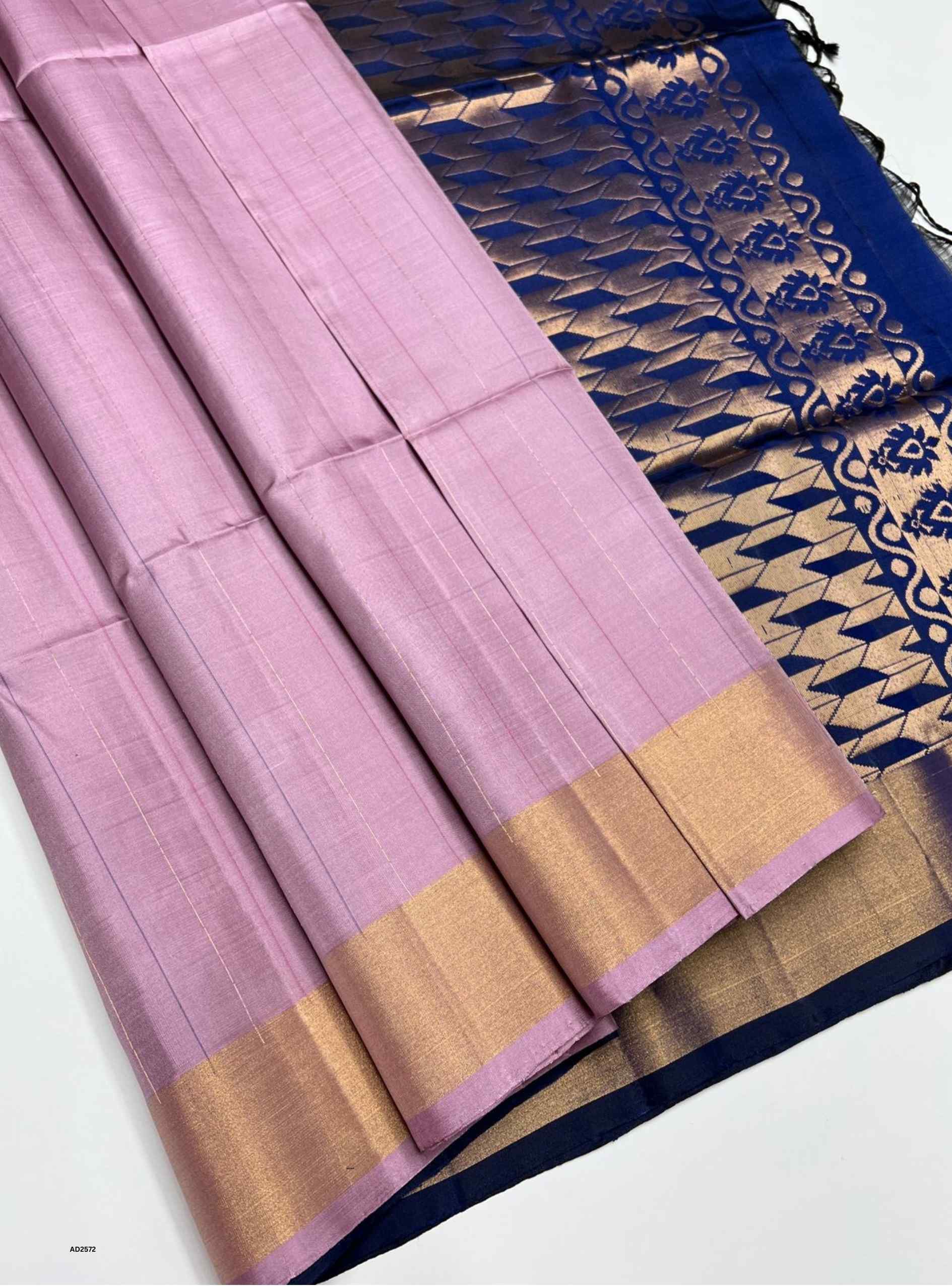 Pink saree with gold border and blue and gold patterned fabric