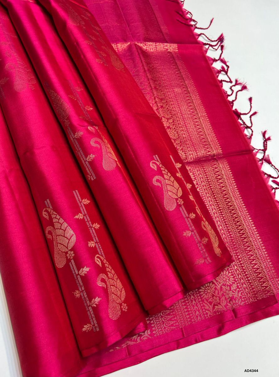 The Rani Pink Fancy Bhutta Soft Silk Saree is a radiant handwoven creation that celebrates festive charm and cultural grandeur. The vibrant rani pink shade conveys joy, devotion, and regal brilliance, while the fancy bhutta motifs add intricate artistry and ornamental richness. Enhanced with pure gold zari borders and a lustrous drape, this saree is perfect for weddings, temple ceremonies, and celebratory occasions. A timeless masterpiece, it blends jewel‑tone vibrance with motif‑centric weaving heritage.