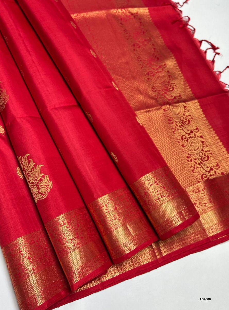 The Red Kanchi Border Soft Silk Saree is a timeless handwoven creation that radiates festive brilliance and cultural richness. The red shade symbolizes devotion, prosperity, and celebratory joy, while the temple‑inspired Kanchi border enriched with pure gold zari elevates its grandeur. Its lustrous drape and coordinated blouse complete the ensemble, making this saree perfect for weddings, temple ceremonies, and festive occasions. A true testament to Kanchipuram artistry, it blends heritage motifs with endur