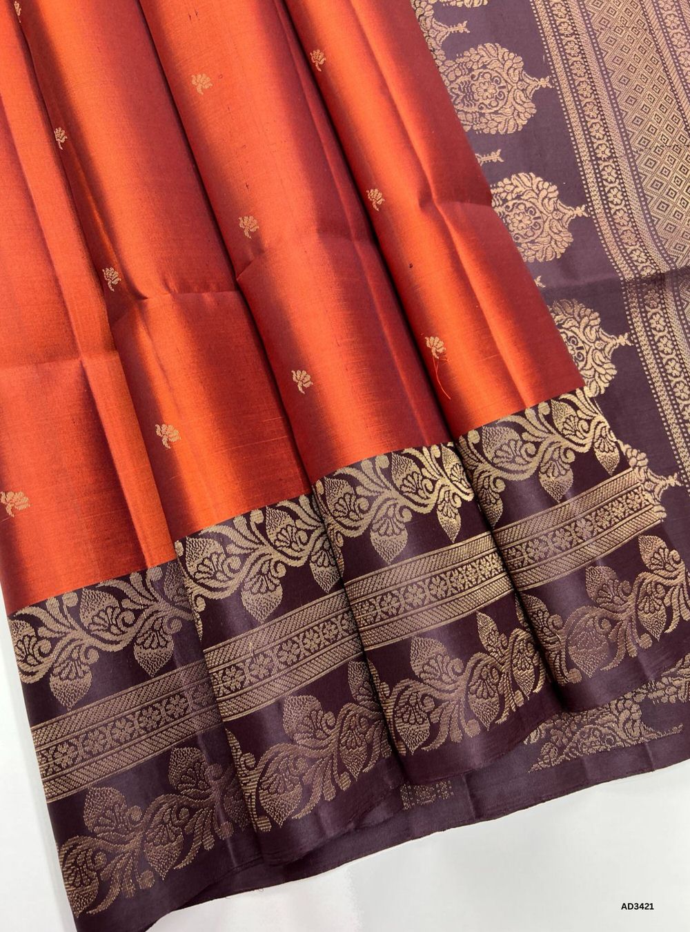 "Handwoven Rust Orange body with Coffee Brown pallu Turning Border Soft Silk Saree featuring gold zari motifs and borders"