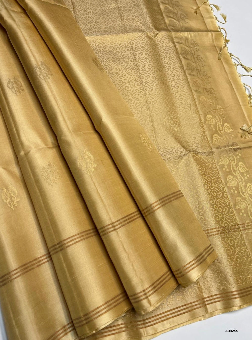 The Sandal Bhutta Soft Silk Saree is a graceful handwoven creation that radiates purity, serenity, and cultural richness. The sandal shade symbolizes auspiciousness, calmness, and timeless elegance, while the bhutta motifs scattered across the body enrich its traditional appeal. Enhanced with zari borders and a lustrous drape, this saree is perfect for weddings, temple ceremonies, and festive occasions. A timeless piece of artistry, it blends motif‑rich weaving with the soothing charm of sandal tones.