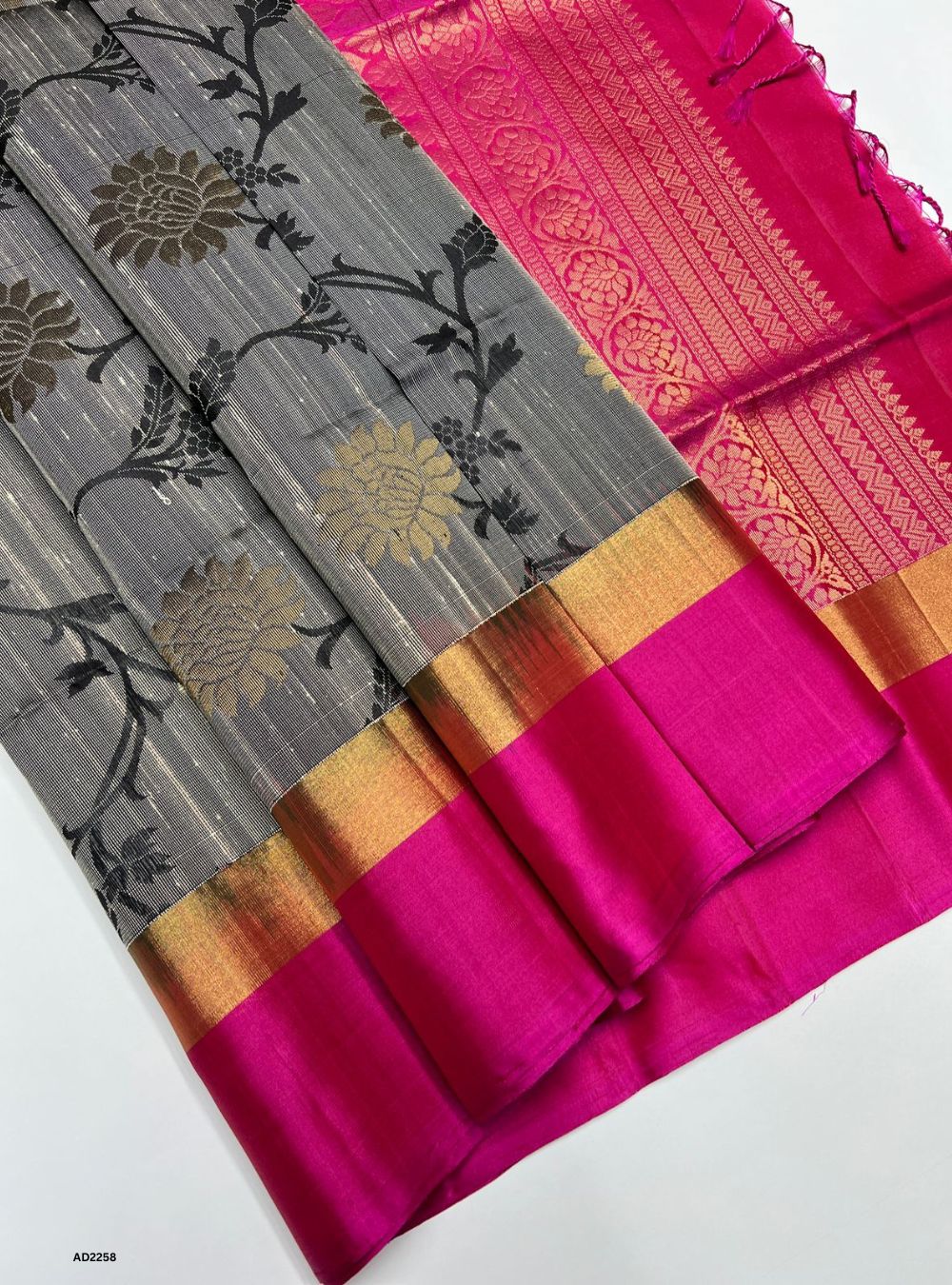 Saree with gray and pink design on a white background