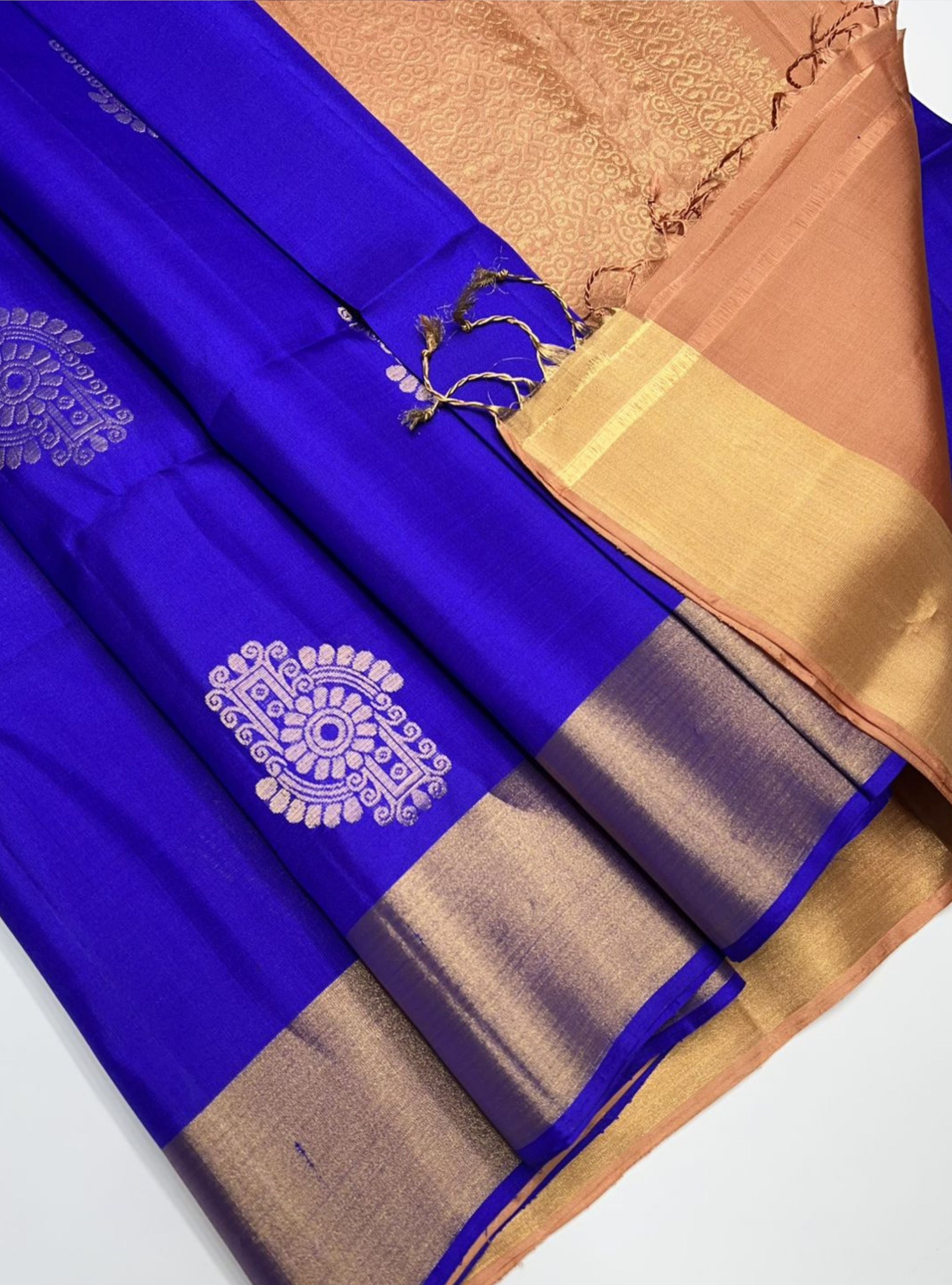Saree with blue, brown, and gold colors on a white background