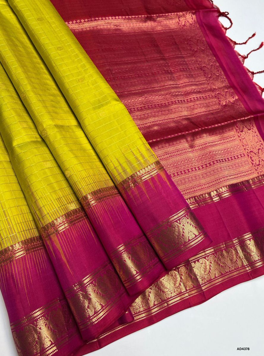 The Yellow & Reddish Pink Checkered Retta Pet Soft Silk Saree is a radiant handwoven creation that embodies festive charm and cultural grandeur. The yellow shade conveys joy, prosperity, and auspicious brilliance, while the reddish pink checks add regal vibrance, devotion, and celebratory depth. Enhanced with pure gold zari borders and a lustrous drape, this saree is perfect for weddings, temple ceremonies, and festive occasions. A timeless masterpiece, it blends vibrant dual tones with the heritage Retta P