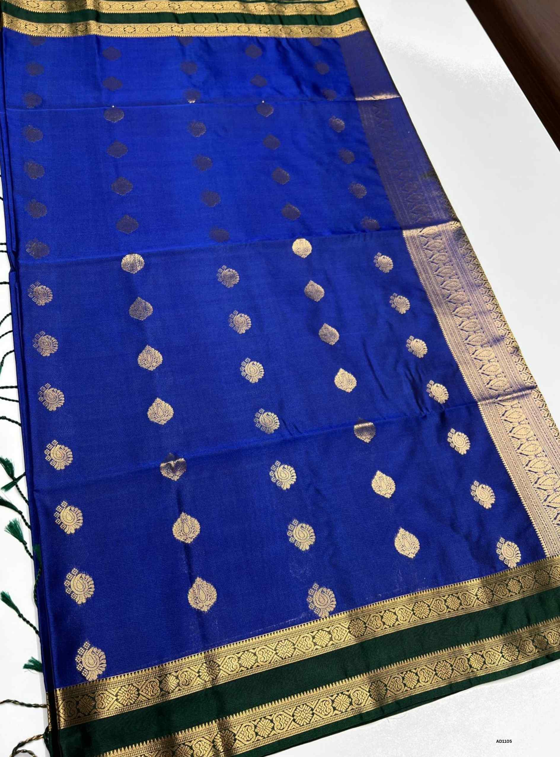 Blue and Green Semi Silk Saree with delicate gold buttas and rich contrasting border.
