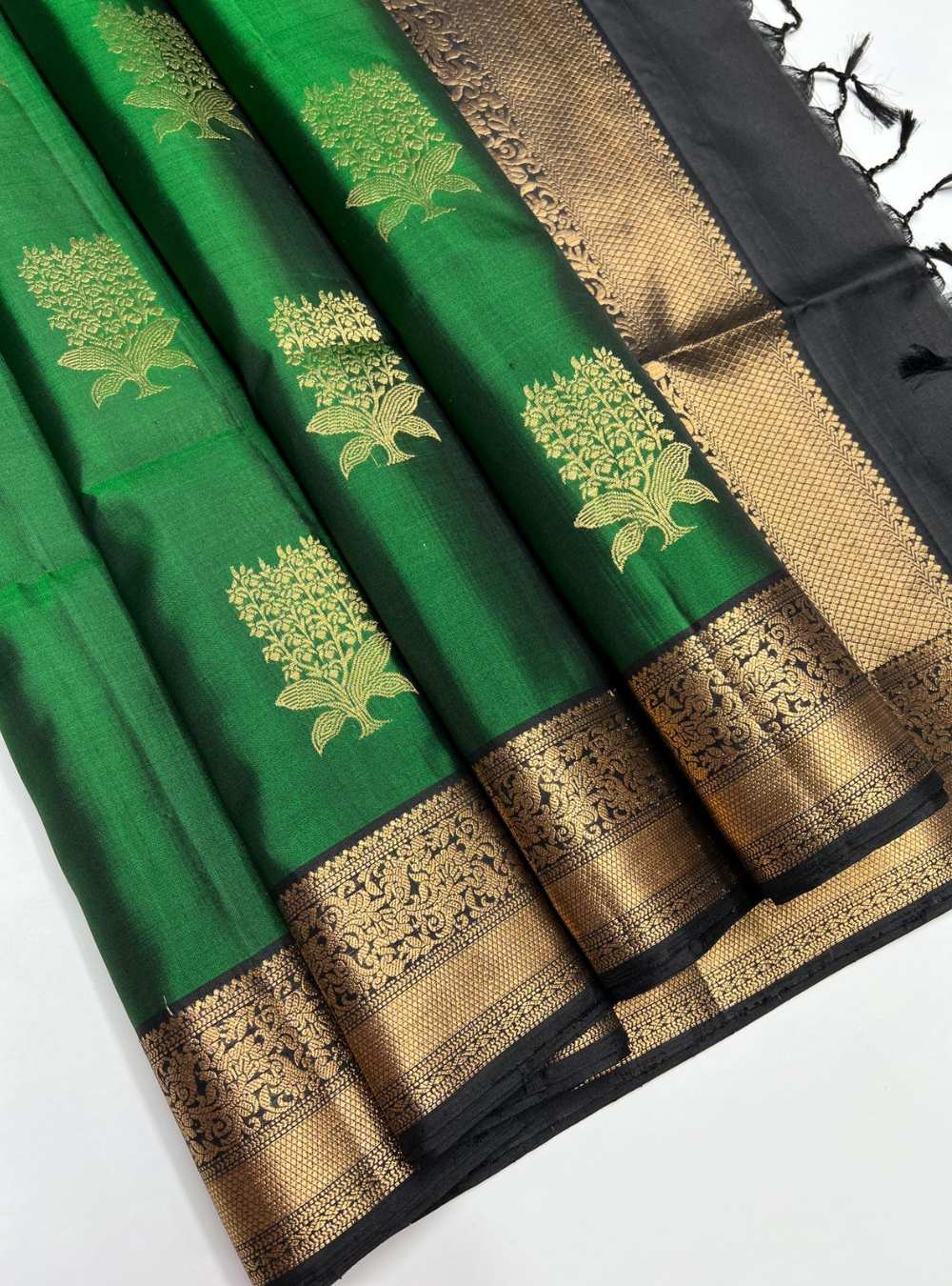 Bottle Green and Black Soft Silk Saree with jacquard border and gold zari motifs, handwoven mulberry silk, festive wear.