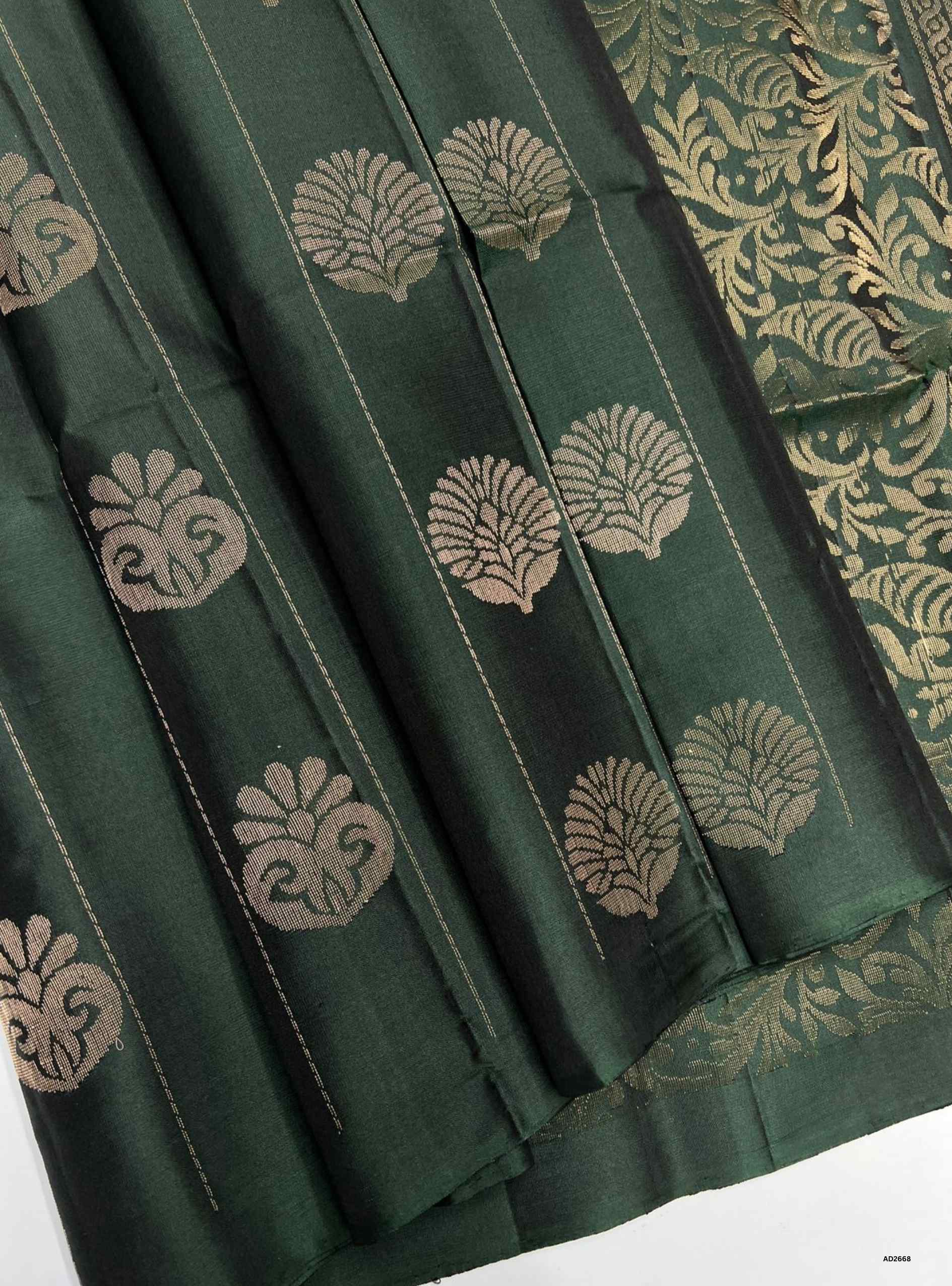 Dark Green Bhutta Soft Silk Saree with gold zari motifs.