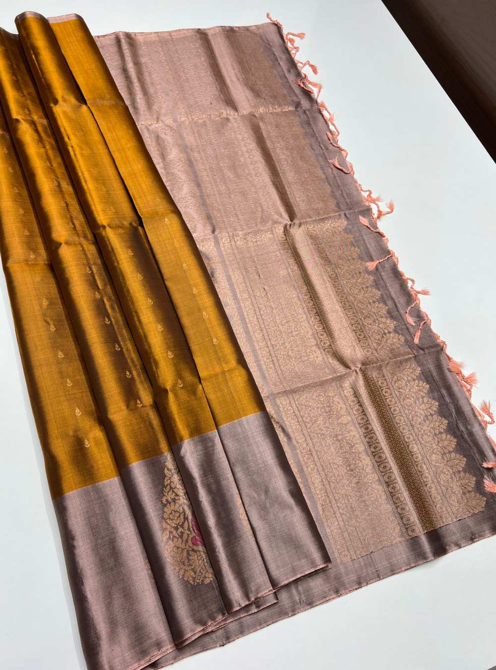 Fenugreek Green and Bronze Soft Silk Saree with fancy design and gold zari motifs, festive wear.