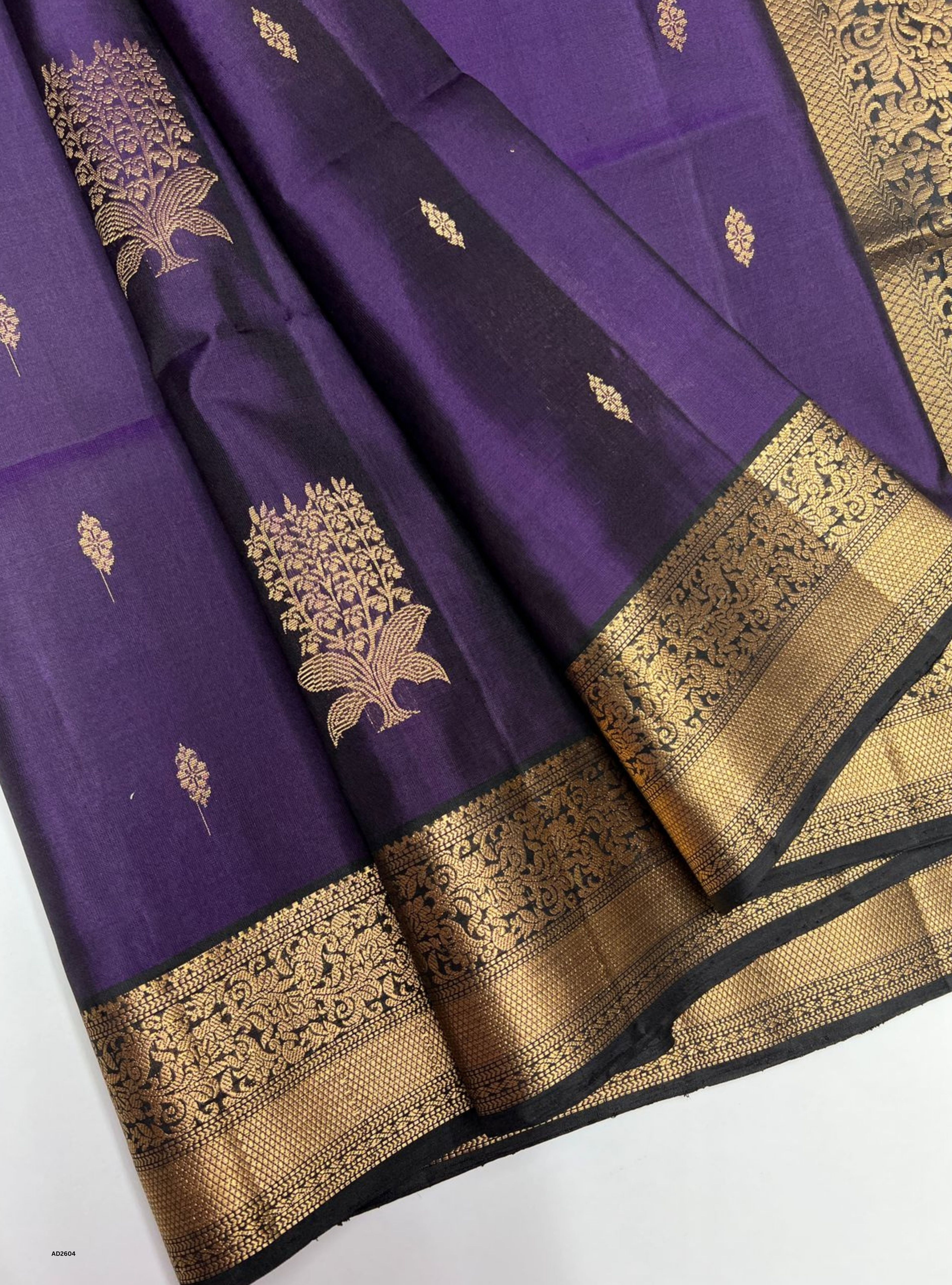 Purple and Black Soft Silk Saree with jacquard border design and gold zari motifs.
